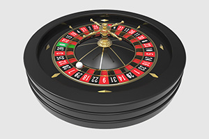 Svart roulettbord med röda, svarta och grönt fack med numrering och en kula placerad i ett av facken.